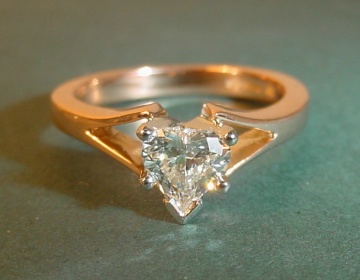 18ct rose gold engagement ring with an H SI 0.45ct heart shaped diamond.