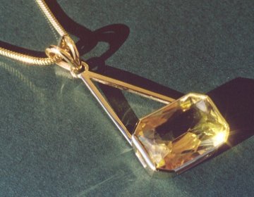 Topaz pendant set in 9ct gold with a filed snake chain.