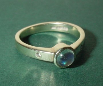 a 9ct white gold engagement ringwith a blue moonstone anddiamonds