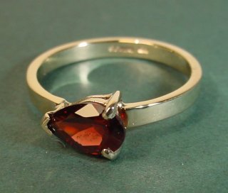 9ct yellow gold engagement ring with a peardrop shaped garnet