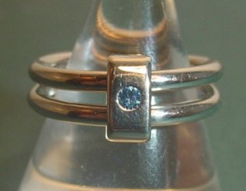 Reversible platinum engagement ring with a diamond and Ceylon sapphire on either side. 