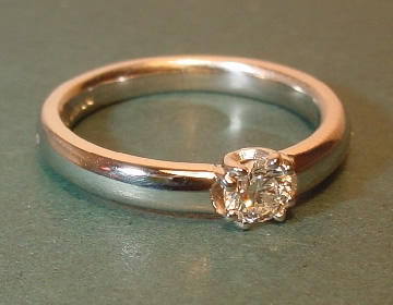 A platinum engagement ring with a brilliant
cut 0.31ct HSI diamond 