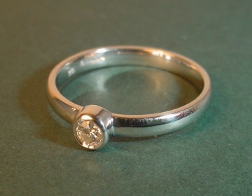 An 18ct white gold engagement ring with a brilliant cut 0.11ct HSI diamond. 