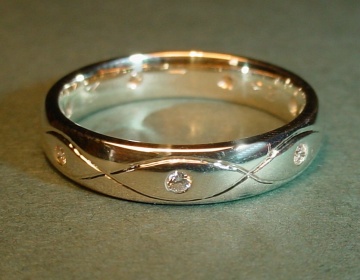 A 9ct white gold eternity ring with diamonds and engraving