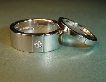 A pair of platinum wedding rings with engraved lines