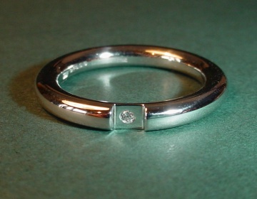 A platinum and diamond solitaire wedding ring