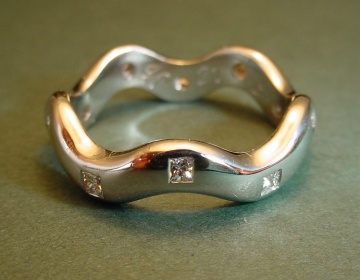 An platinum wedding/eternity ring set with diamonds