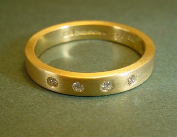 A 9ct yellow gold wedding/eternity ring set with white and cognac diamonds