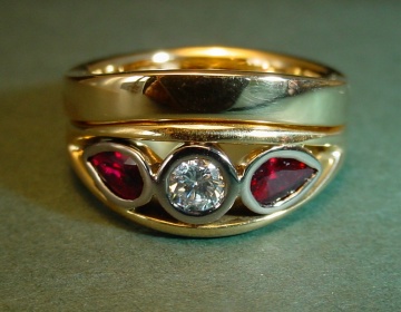 A yellow gold engagement and wedding ring set with rubies and diamonds