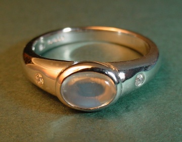 18ct white gold engagement ring with a blue moonstone and 1.5mm diamonds