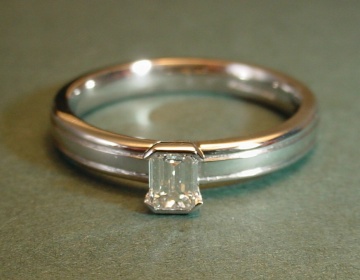 Platinum solitaire with an emerald cut diamond 