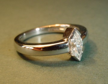 Simple platinum engagement ring with marquise cut diamond