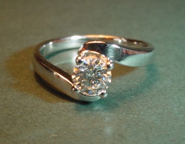 Simple cross-over style 0.51cts H SI platinum solitaire engagement ring