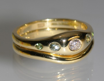 flush engagement ring with diamond, green sapphires and tourmalines