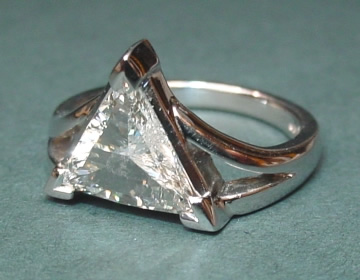 Dramatic platinum engagement ring with 0.85cts triangular diamond.