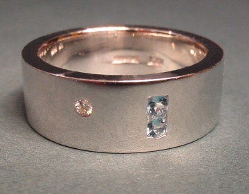 9ct white gold wedding ring with aquamarines and a diamond.