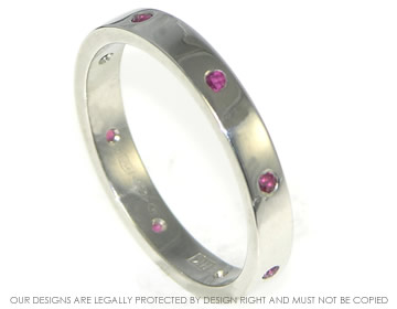 A platinum eternity ring with 8 rubies set around the shank 