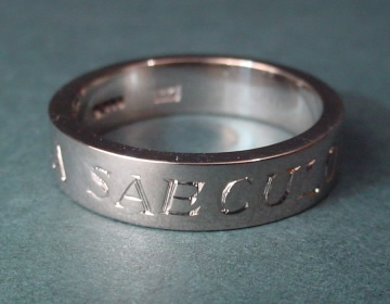 Simple chunky 18ct white gold wedding band with latin engraving