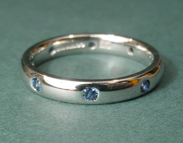 Platinum ring with 8 equally spaced medium-pale blue Ceylon sapphires