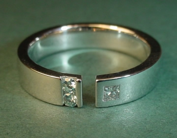 Unusual ring with white princess cut diamond and ice blue heat-treated diamonds