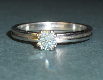 Platinum and ice Blue 0.24ct brilliant cut heat-treated diamond engagement ring.