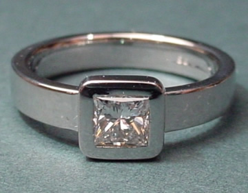 Platinum engagement ring with a princess cut diamond.