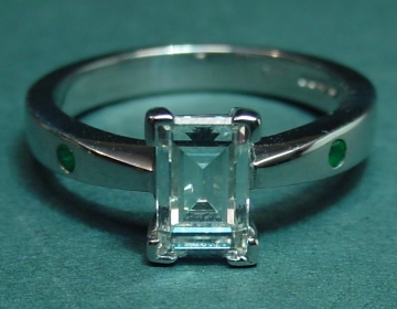 Platinum diamond and emerald engagement ring 