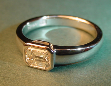 Bespoke platimun engagement ring with emerald cut diamond