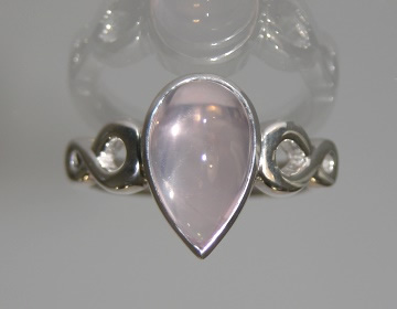 White gold ring with rose quartz pear shaped stone and infinity symbol details.