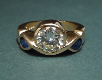 18ct yellow gold engagement ring with a diamond and pear shaped  sapphires