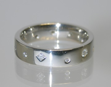 Contemporary platinum ring with randomly spaced scattered diamonds