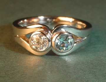 Platinum engagement ring with a diamond and an aquamarine.