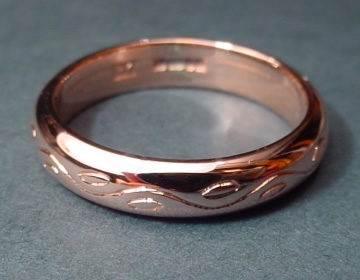 9ct rose gold wedding ring with engraved detailing.