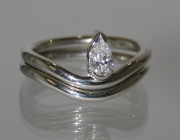 Unusual delicate looking platinum 0.26cts solitaire and matching wedding ring