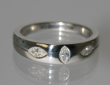 Flush set platinum ring with 3 marquise cut H SI diamonds