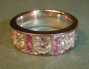 Heavy platinum ring with diamonds and pink sapphires.