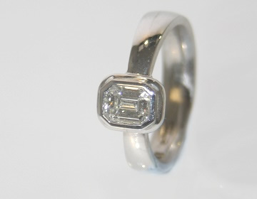 18ct white gold engagement ring with an emerald cut 0.55ct diamond