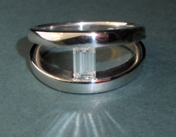 Platinum and diamond 'tension' look engagement ring.