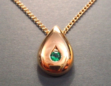 18ct yellow gold teardrop pendant with a brilliant cut emerald.