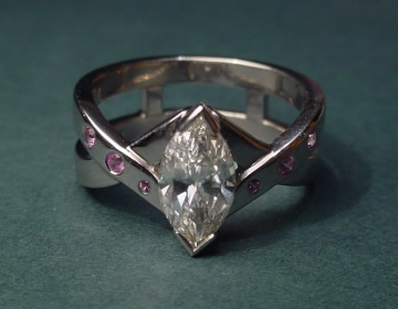 Bespoke ring with marquise diamond, amethysts and cross-over design