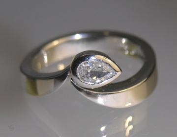 Platinum engagement ring with a pear shaped diamond  