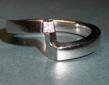 Platinum fitted wedding ring with a diamond.