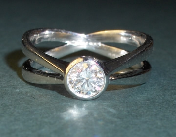 Platinum and diamond crossover engagement ring.