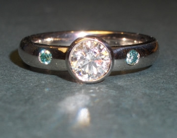 18ct white gold engagement ring with white and blue diamonds.