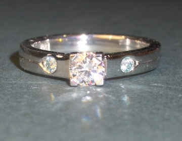 Platinum engagement ring with white and ice blue diamonds.