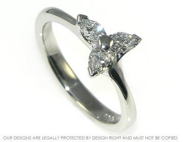 Elegant platinum engagement ring with three pear shaped diamonds