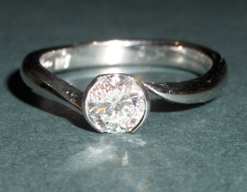 Bespoke engagement ring with a delicate twist style band.