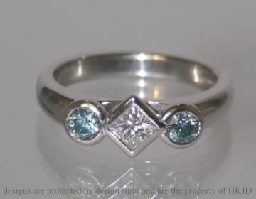 Platinum engagement ring with 0.63cts white and sky blue heat-treated diamonds