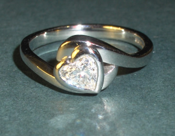 Platinum 'embraced heart' Diamond solitaire engagement ring