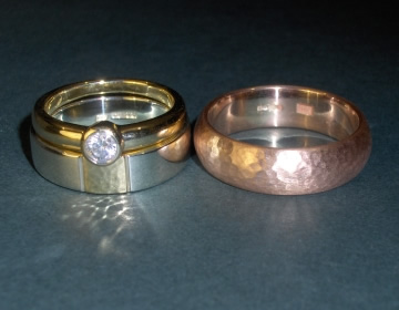 A pair of hammer finished and satinised commissioned wedding rings